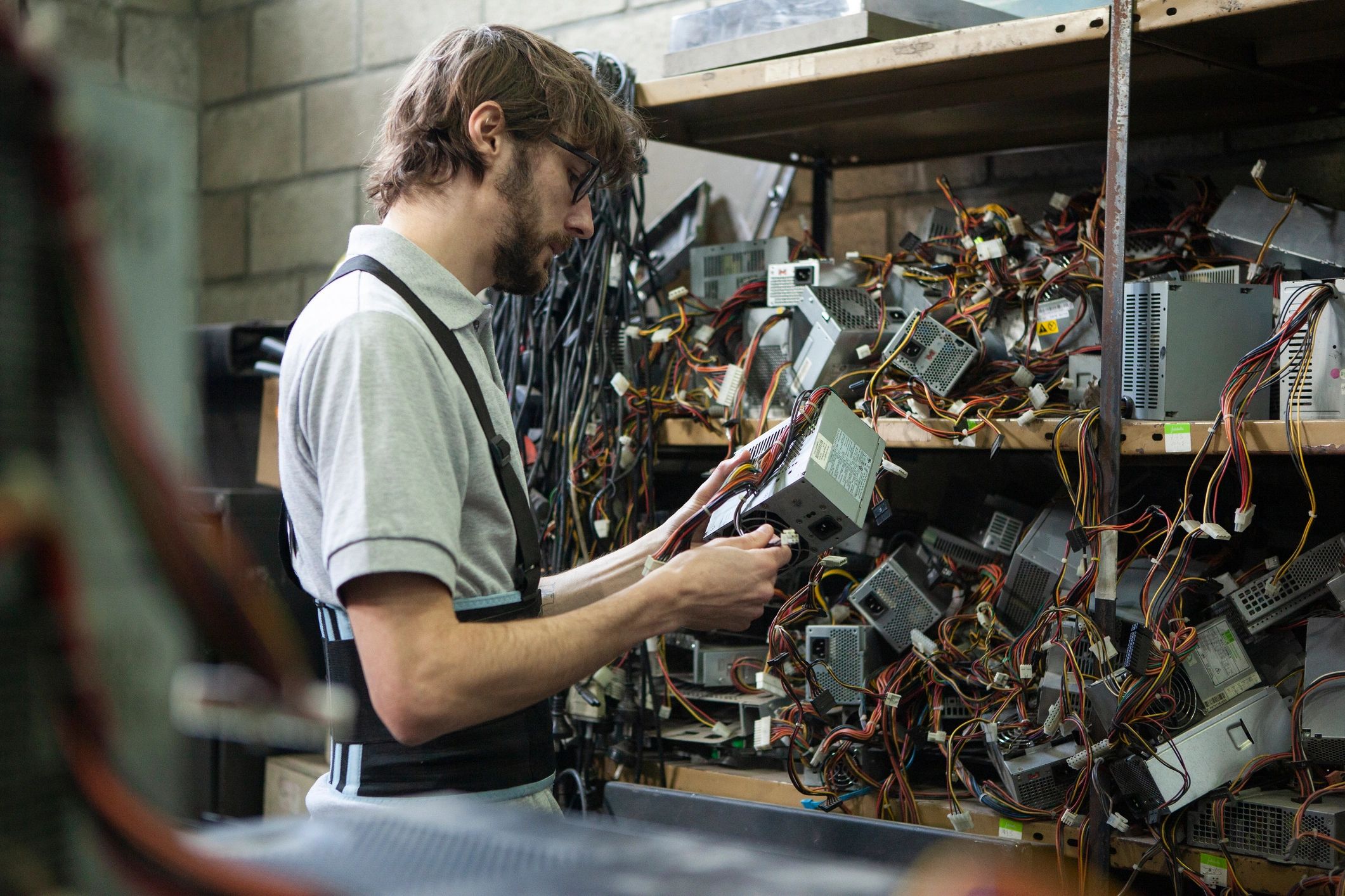 Technician inspecting electronic components in a workshop