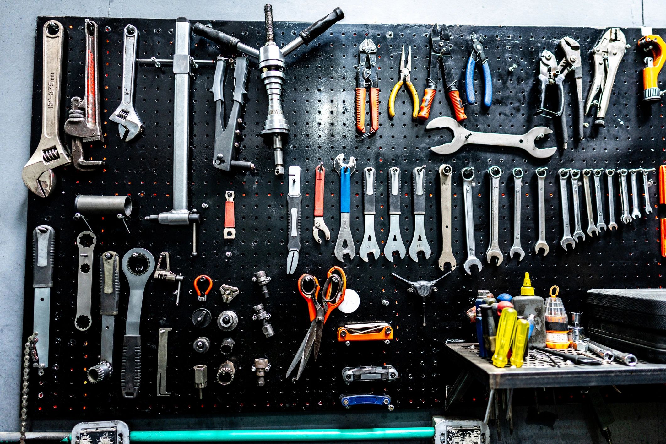 Electronics repair tools on a workshop wall