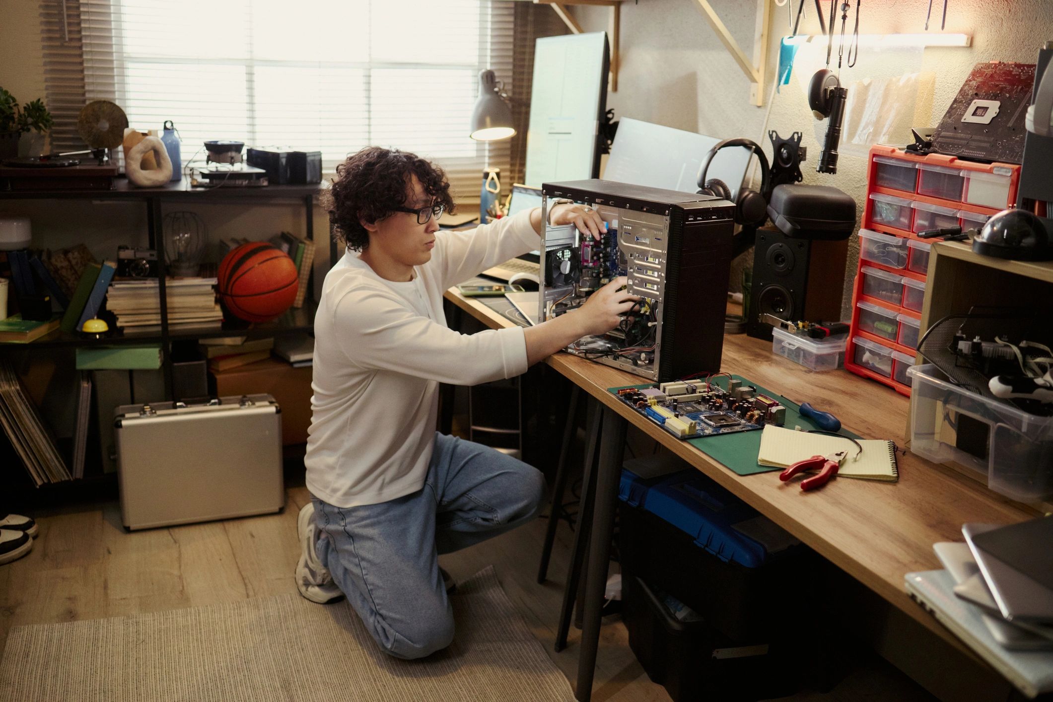 Technician repairing electronic equipment at a workbench